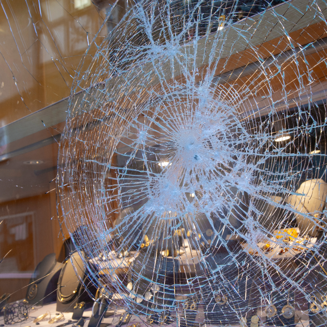 Damaged glass showing the importance of protective commercial window tinting film.