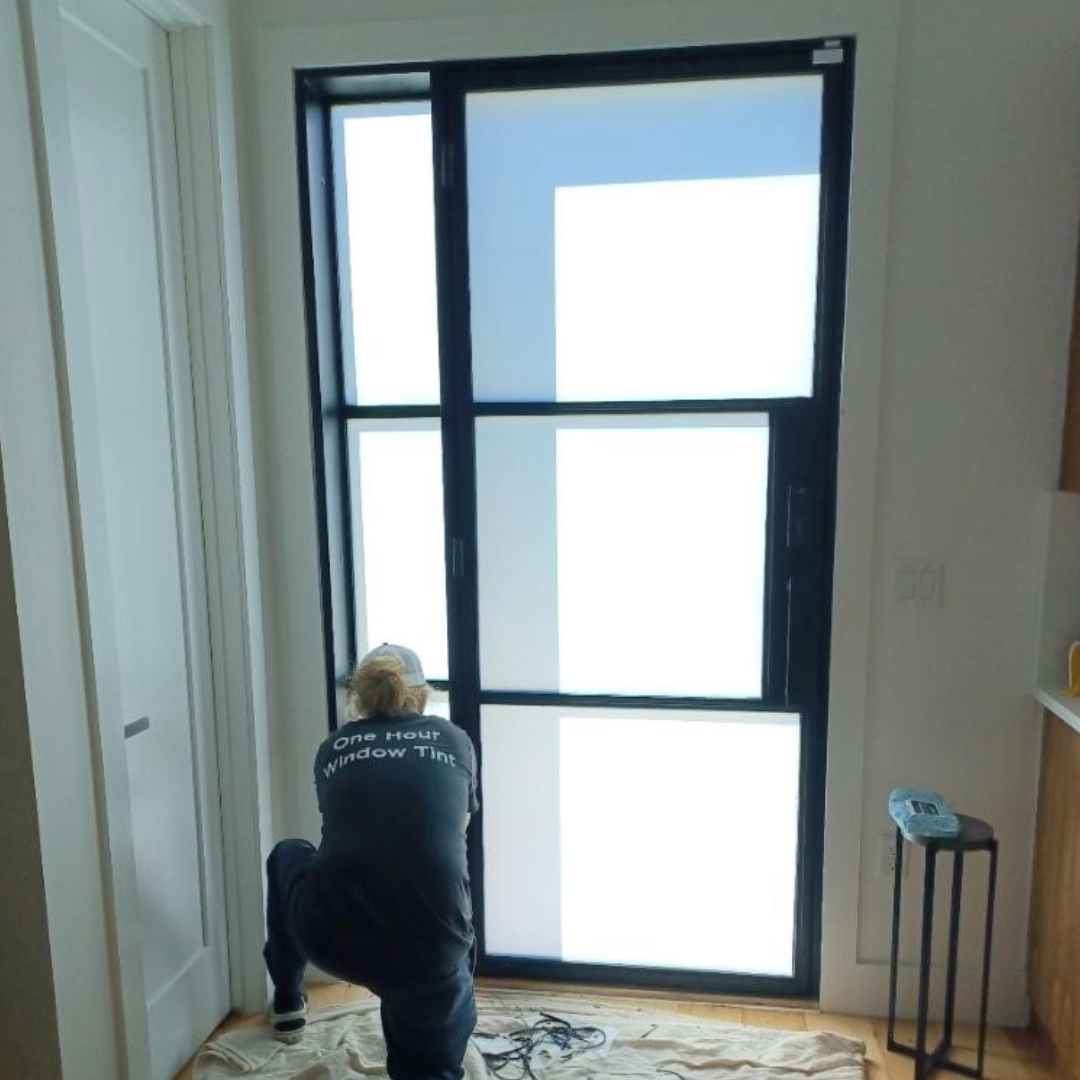 Turbo Tint technician installing residential window tint film on a home window.