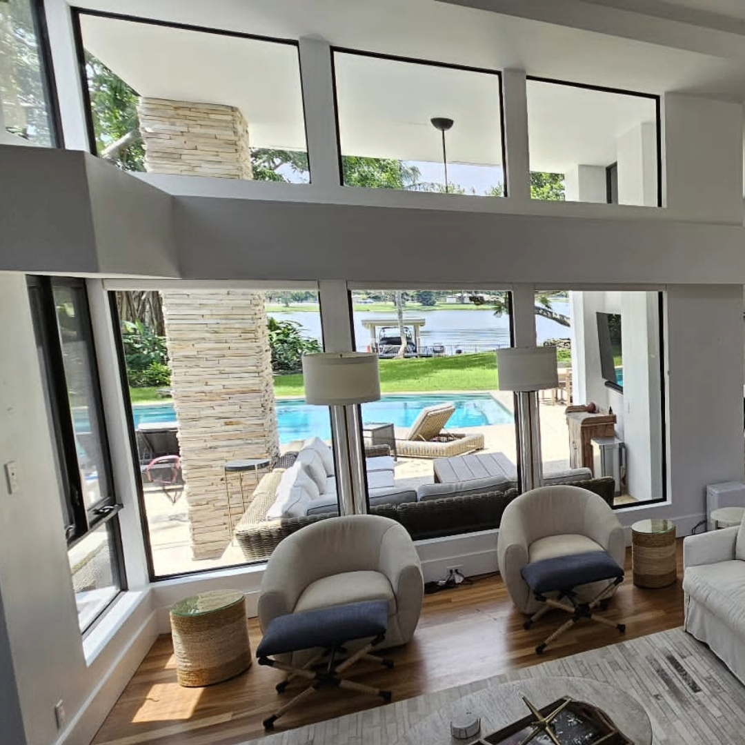 Residential window tinting in a bright living area with indoor pool and couch.