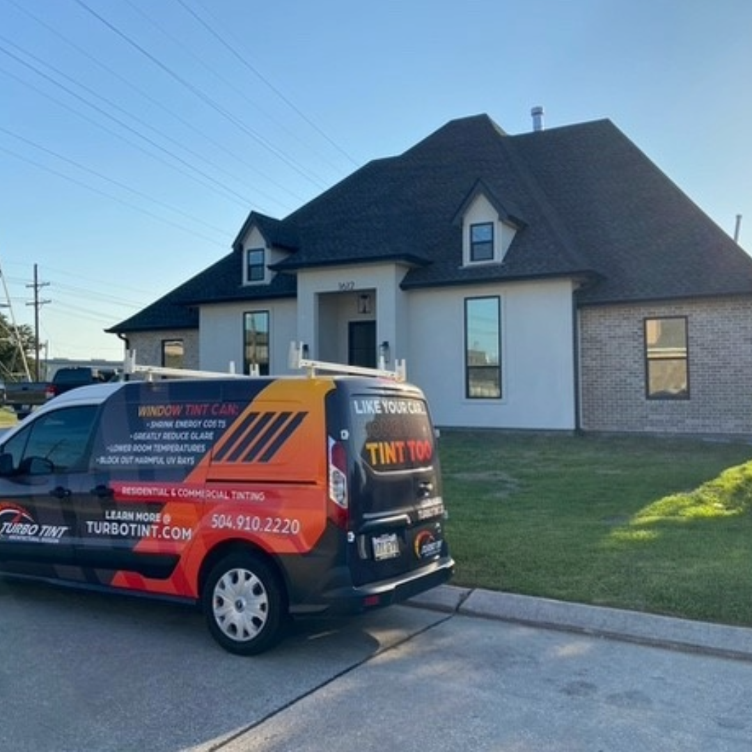 Residential window tint services van parked outside a private home.
